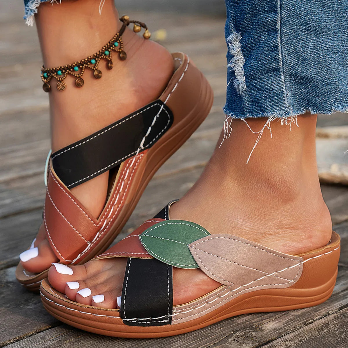 Women's black cross-strap peep-toe slippers with a thick sole, shown from the side.