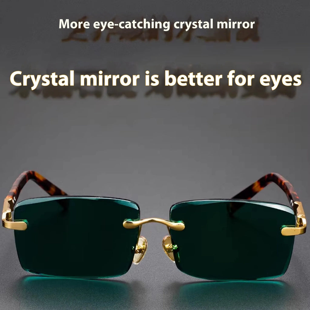 A pair of dark green frameless crystal sunglasses presented with a matching glasses case and a lens cloth.