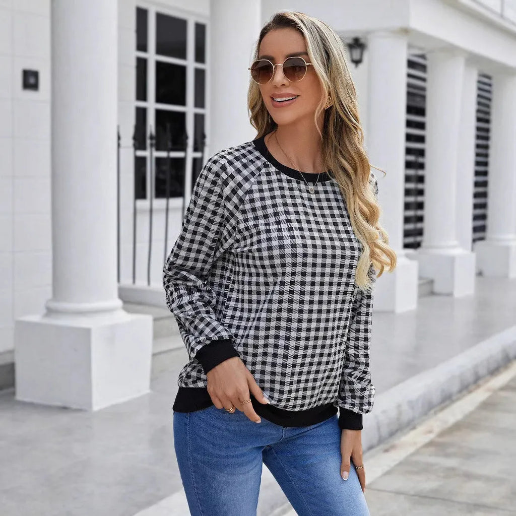Black long sleeve plaid pullover sweater with Japanese style printing laid flat.