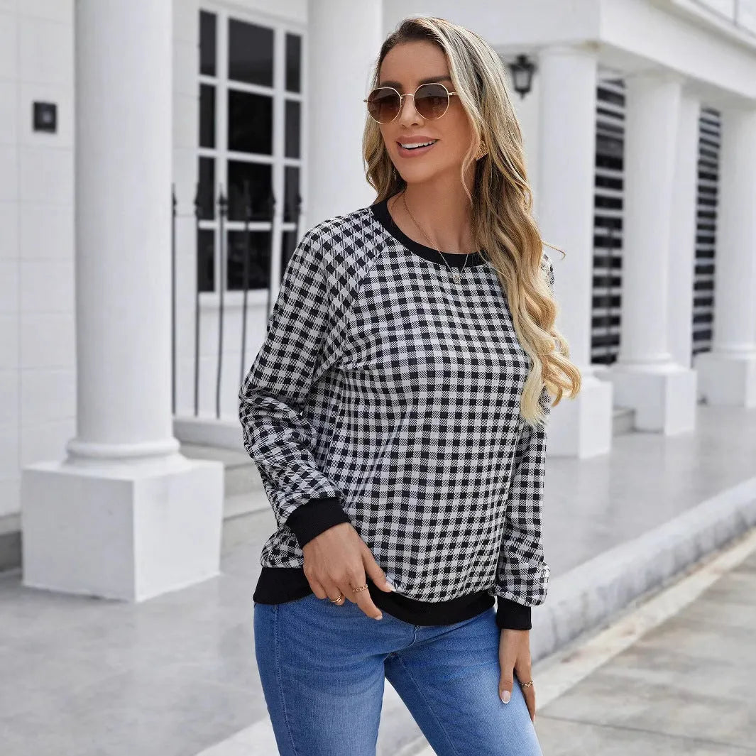Black long sleeve plaid pullover sweater with Japanese style printing laid flat.