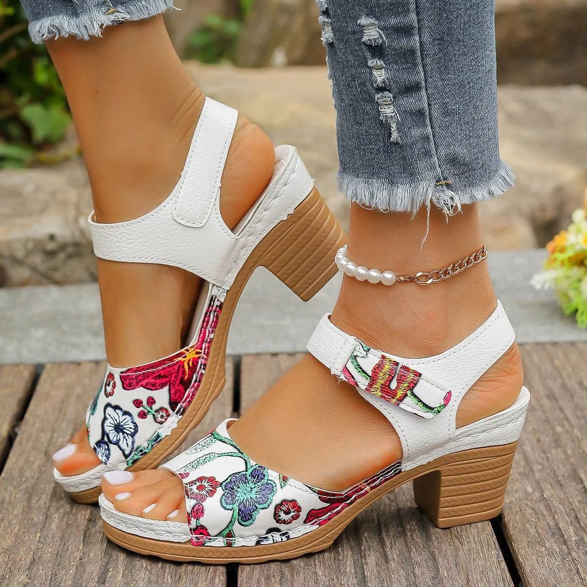 White women's high heel sandals with a Velcro strap buckle on a rubber sole.