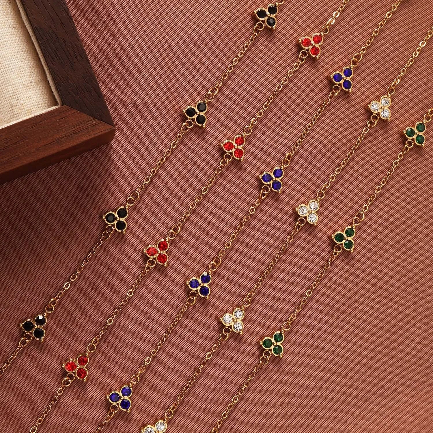 Women's stainless steel geometric bracelet with triangle design and coloured zircon stones.