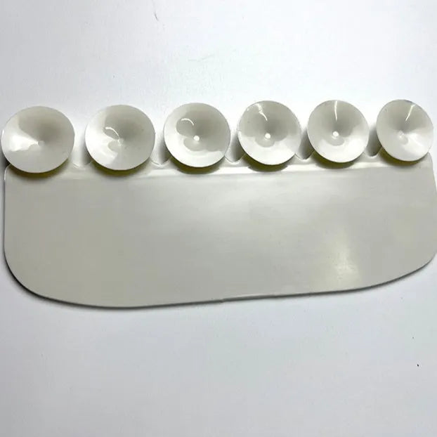 White PVC toilet urine blocking board placed on standard toilet seat