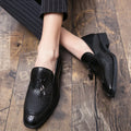 Men's black pointed slip-on shoes with a tassel detail on the front, made from artificial PU.