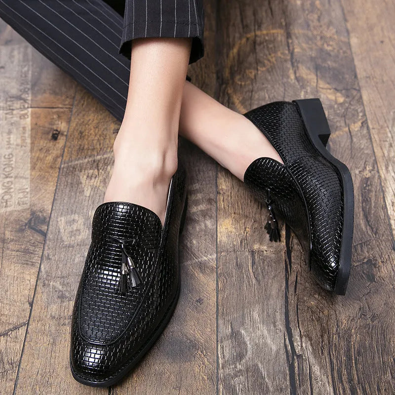 Men's black pointed slip-on shoes with a tassel detail on the front, made from artificial PU.