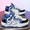 Men's white chunky sneakers with cartoon design, thick rubber sole, and lace-up front.