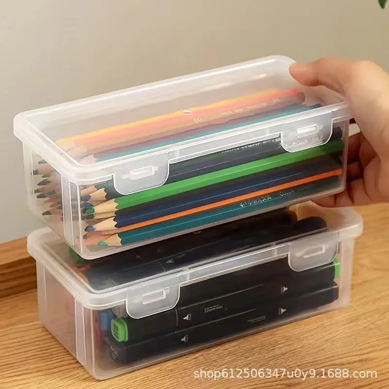 Transparent plastic stationery storage box with pencils and crayons inside