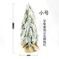 Small 24-inch artificial Christmas tree with snow-spray branches and built-in lights for desktop decoration