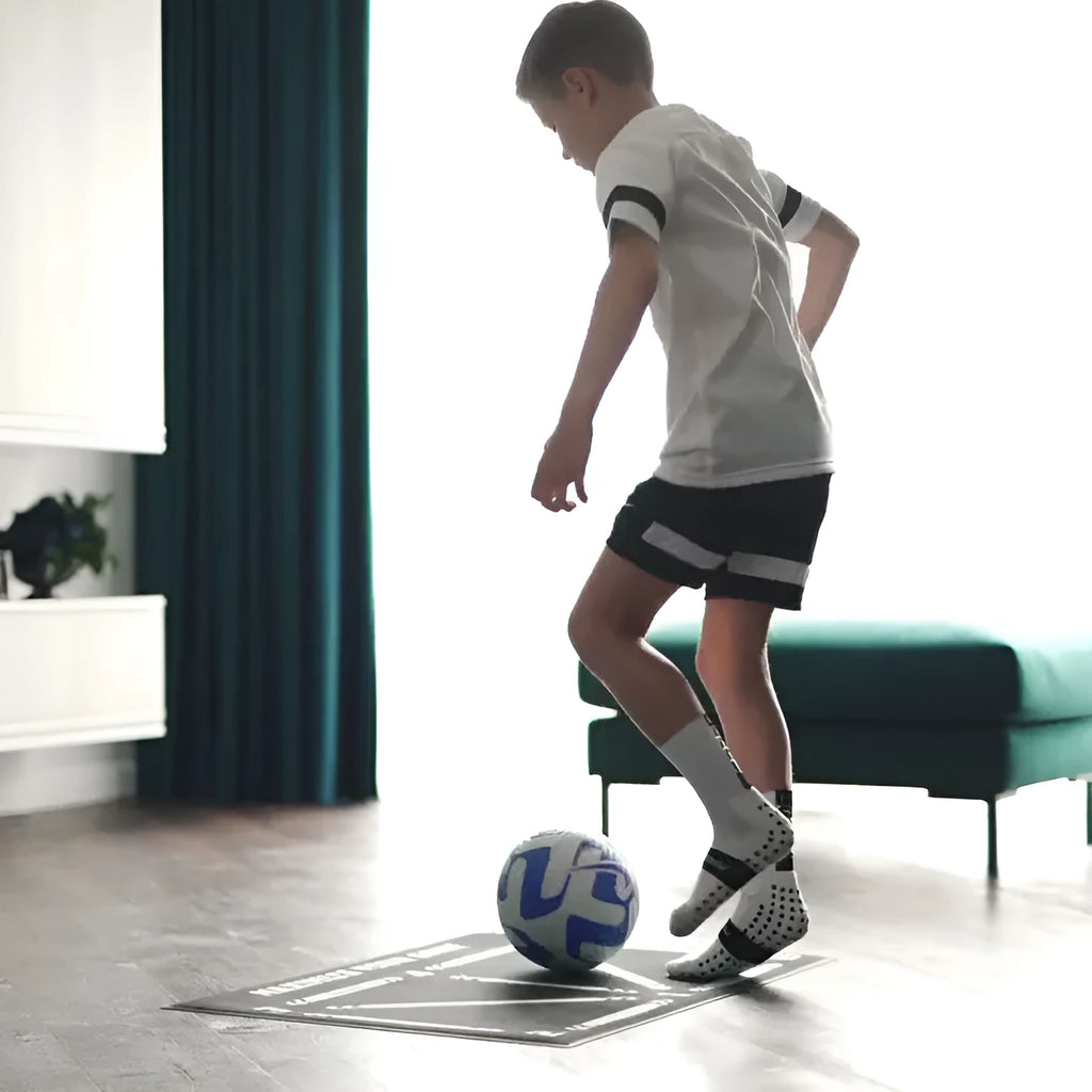 Black rectangular football training mat with non-slip backing measuring 60cm by 90cm