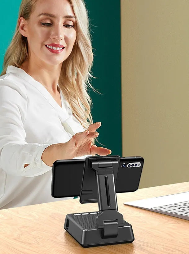 Black mobile phone broadcaster stand with integrated Bluetooth speaker and HD microphone on a desk.