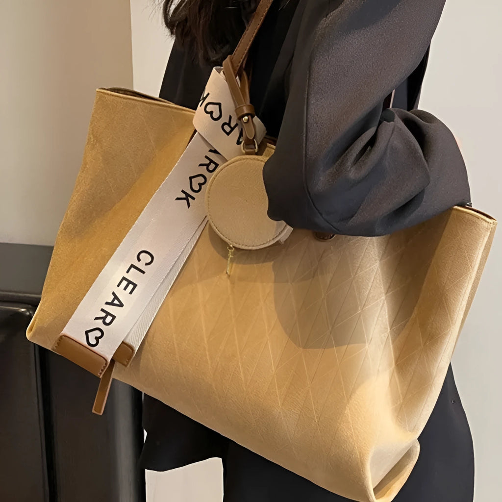 Soft large casual shoulder tote bag in a horizontal square shape with a sandwich pocket and sewing thread detail.
