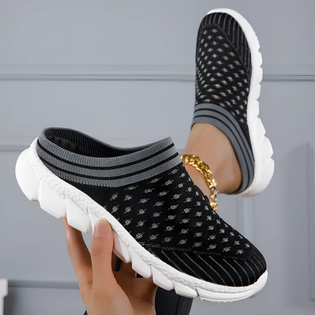 Black, pink, and purple striped Flyknit women's sports slippers with hollowed-out design on a viscose sole.