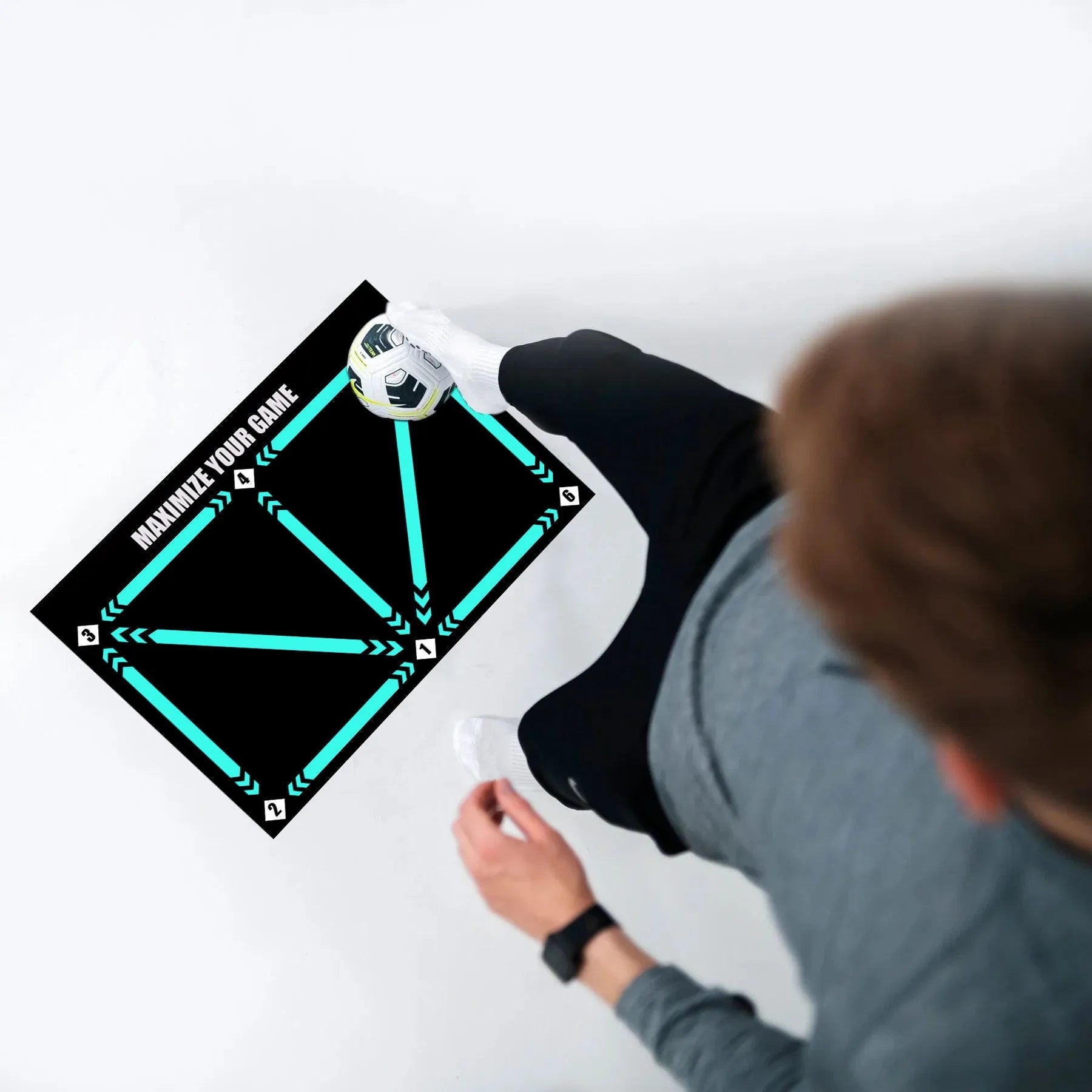 Black rectangular football training mat with non-slip backing measuring 60cm by 90cm