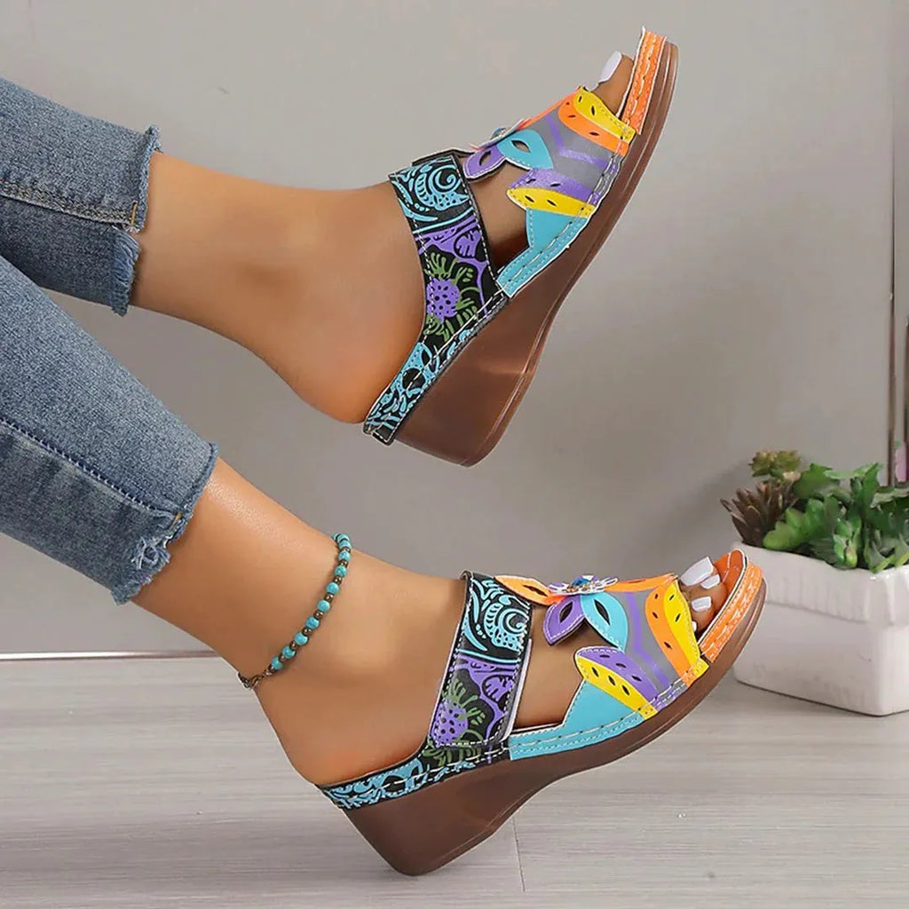 Colourful ethnic print cowhide leather slippers with round toe and rubber sole.