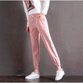 Quick-drying women's track pants in solid colour, loose-fit harem style with elastic waist