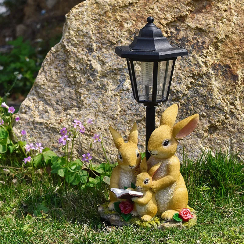 Solar hexagonal garden lamp with resin sculpture decoration in garden setting