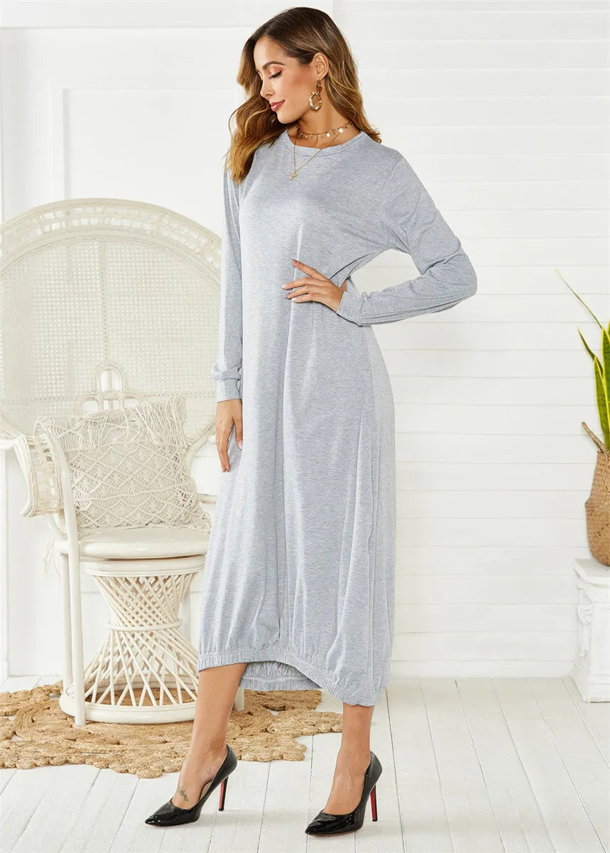 Loose black lantern dress with lace-up crew neck and long sleeves, laid flat.