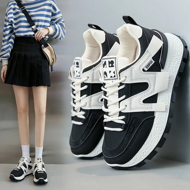 Artificial PU low top running sneakers in white and black colours with front lace-up design