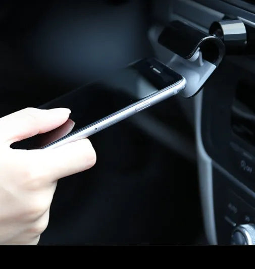 Black universal car phone holder with 360-degree rotation mounted on vehicle air vent