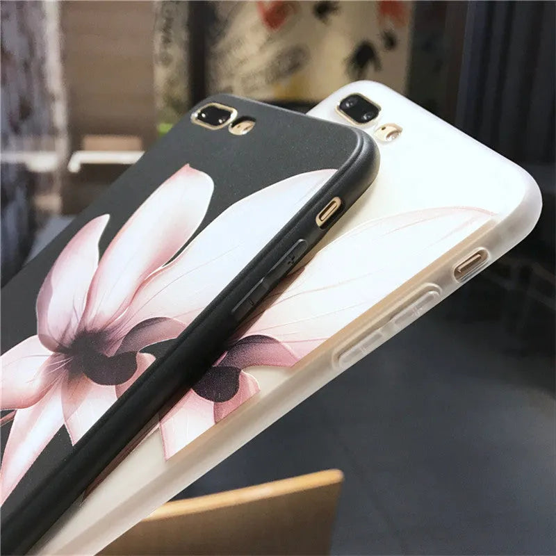 Black TPU iPhone case with a white raised embossed floral pattern on the back.