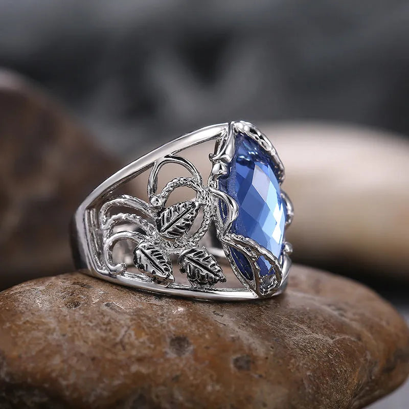 Blue crystal horse eye geometric ring on alloy band showing side profile