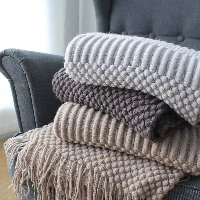 Small grey polyester blanket folded, dimensions 127 by 170 centimetres.