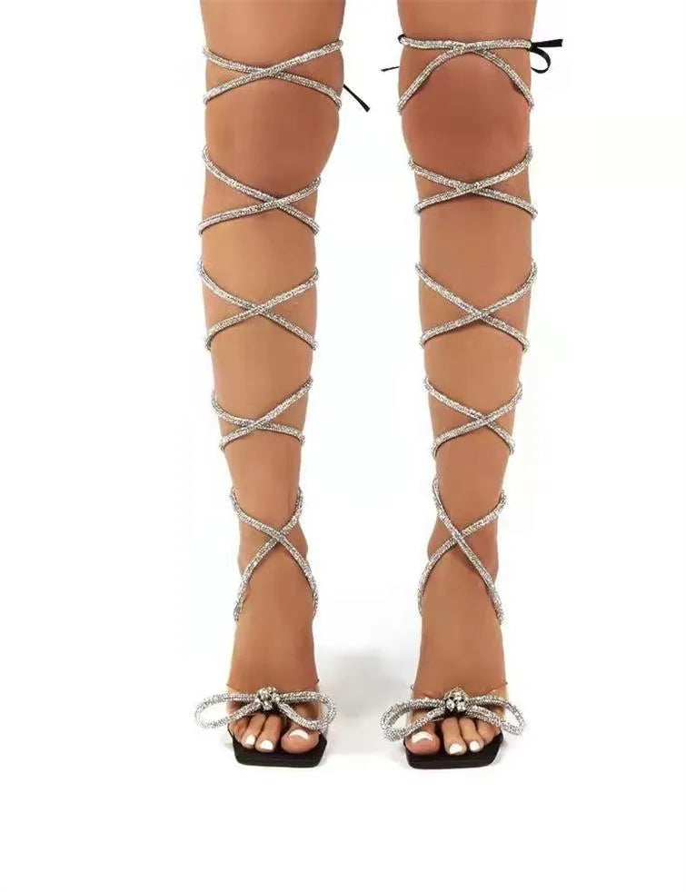 Plus size women's strappy sandals with Roman rhinestone straps and a square toe in black.
