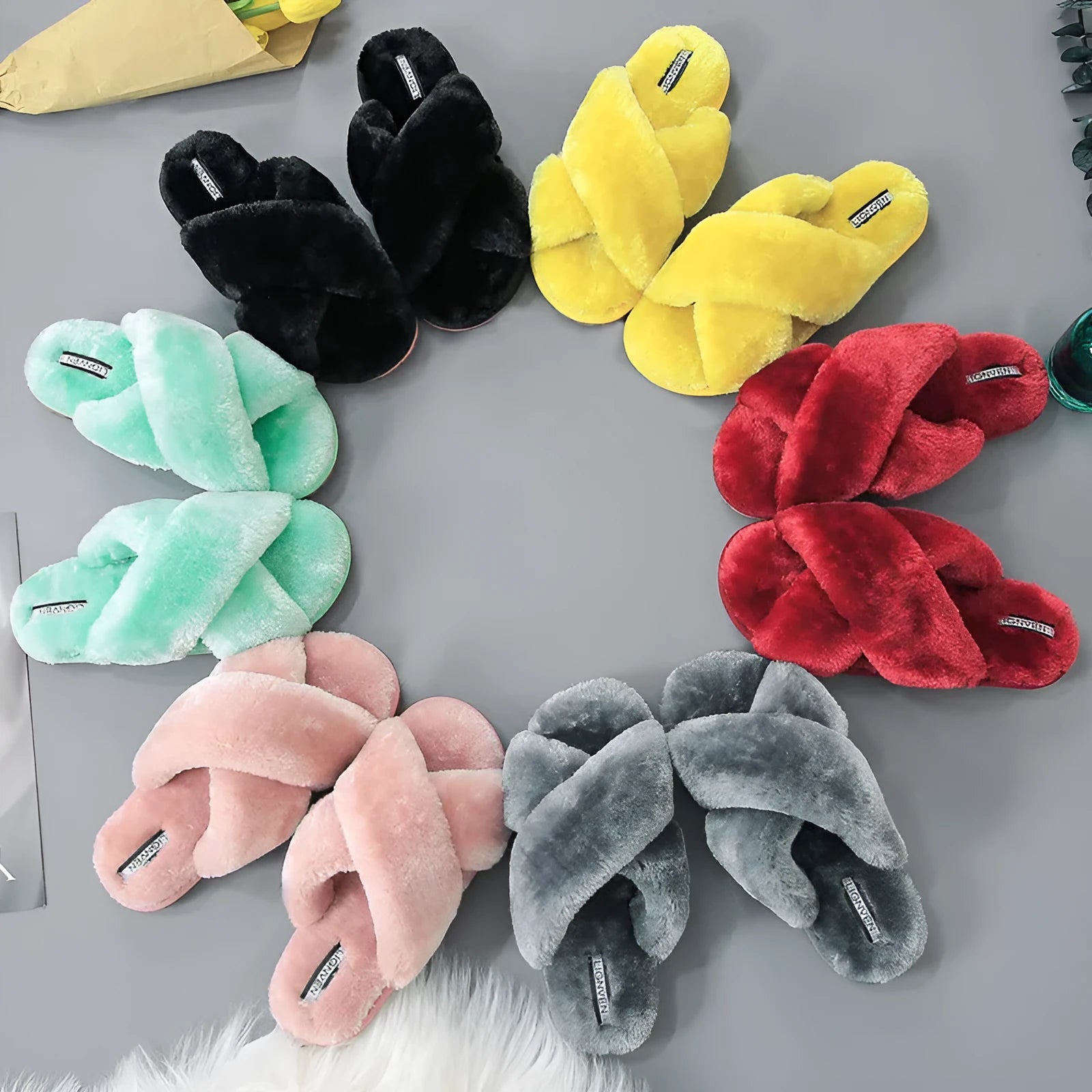 Women's black cross open-toe fur slippers on a non-slip patterned sole.