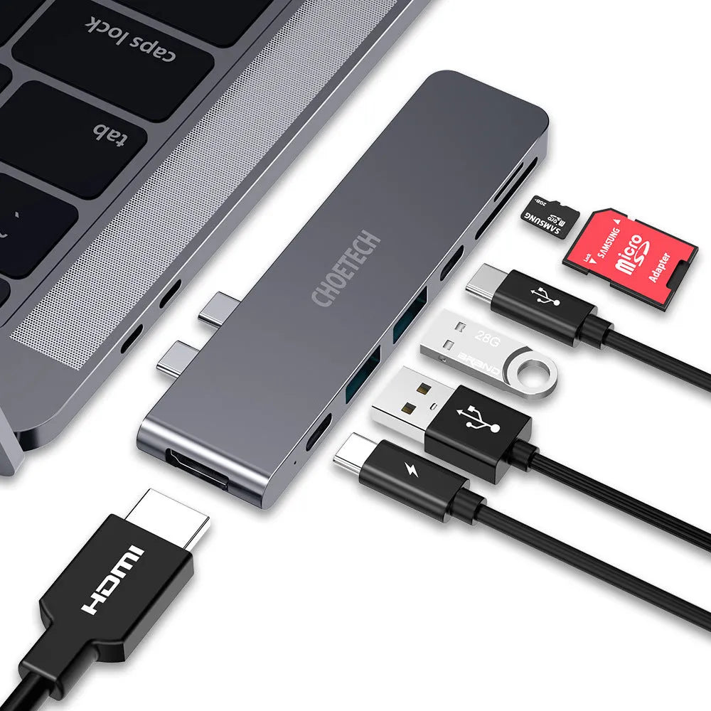 Silver USB-C to multi-port adapter hub with SD card slot, HDMI, USB ports, and PD charging