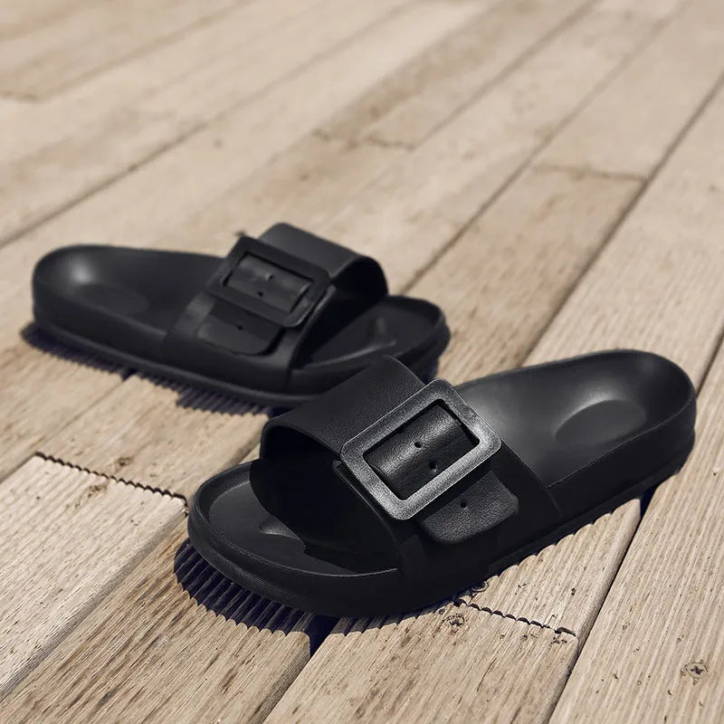 Women's grey blue buckle slippers with a soft EVA sole and single buckle closure.