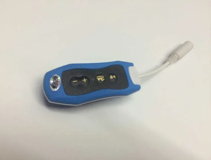 Compact black Bluetooth MP3 headset with USB cable, shown next to scale for size.