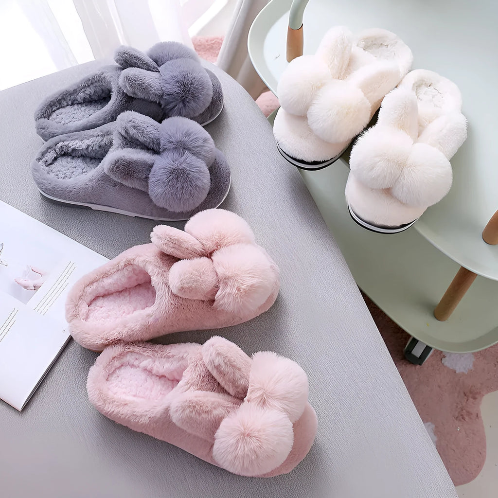 Women's rabbit fur slippers in grey with flower details and a high upper.
