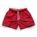 Men's black polyester beach shorts with straight leg opening on a mannequin