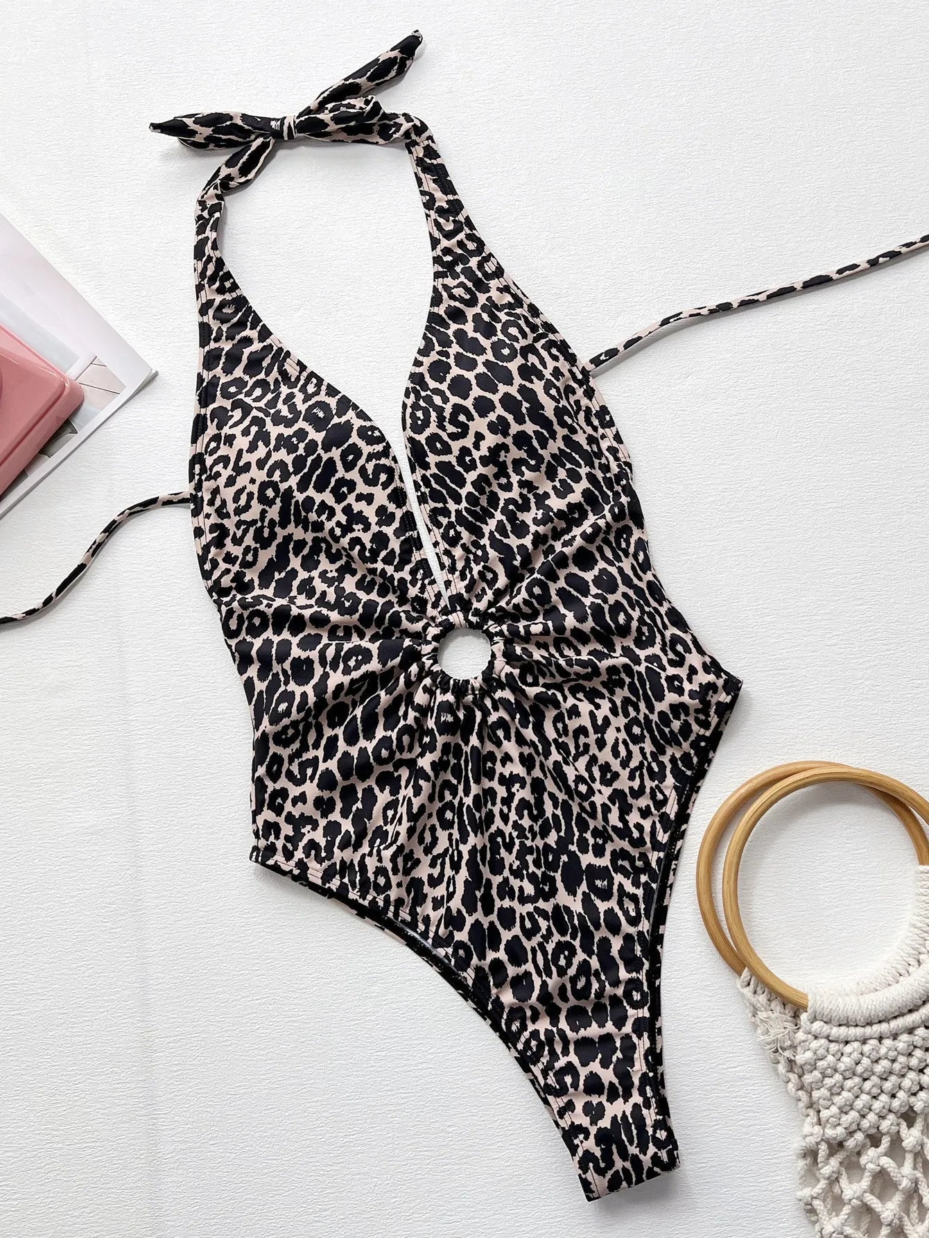 Leopard print women's one-piece swimsuit with hollow-out ring bikini detailing on a mannequin.