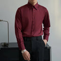 Man wearing a black Japanese retro style loose-fit long sleeve cardigan shirt.