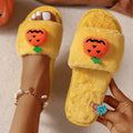 Yellow and white cartoon pumpkin plush slippers with synthetic fur and PVC anti-slip sole.
