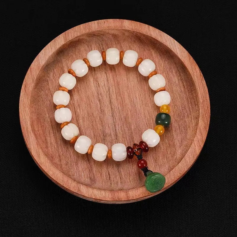 Carved pumpkin lotus Bodhi root bracelet with white jade beads and multiple dimensions