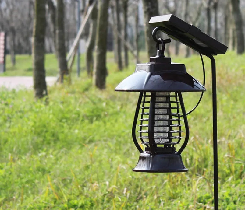 White solar-powered electronic mosquito lamp with solar panel and purple switch for garden outdoor use.