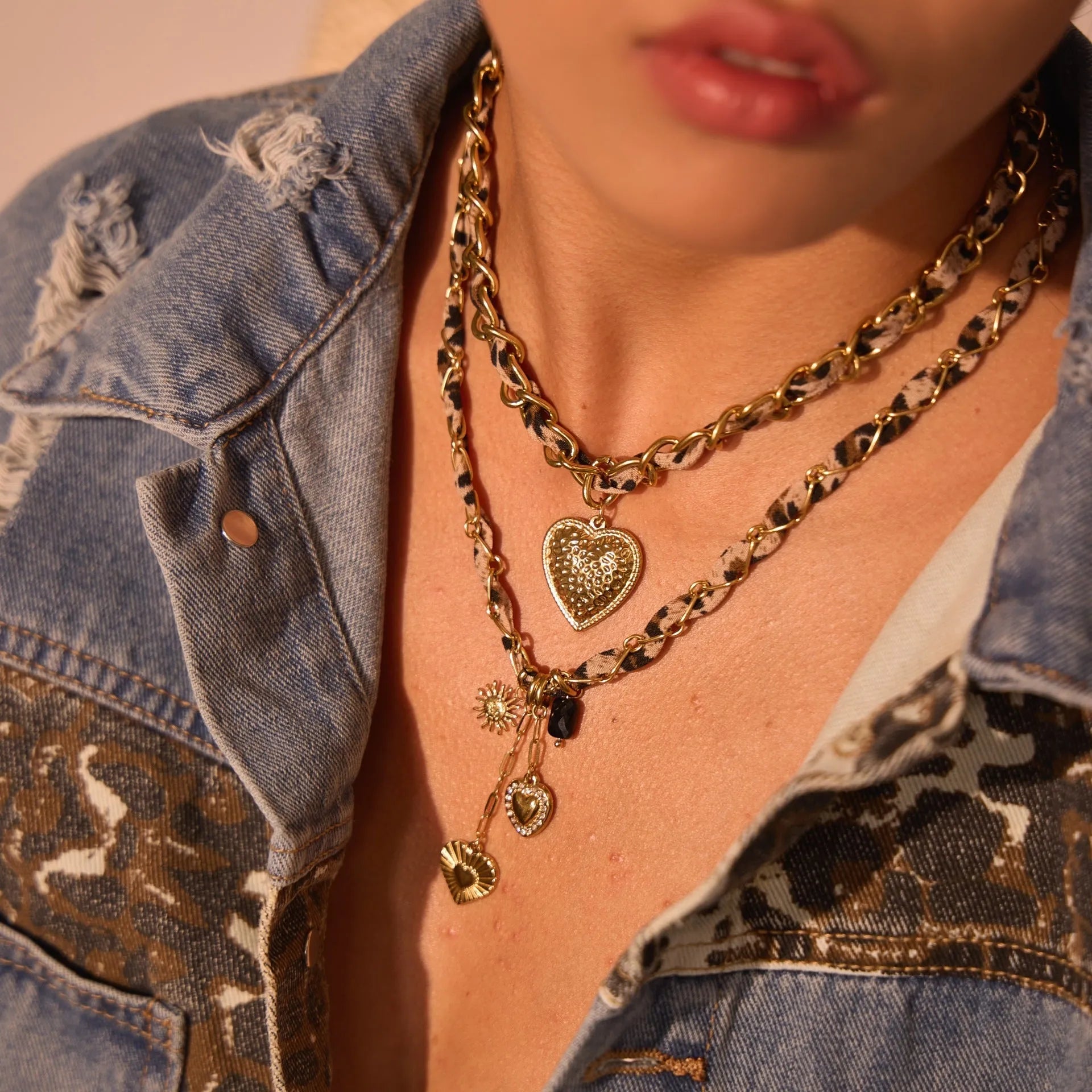 Gold plated leopard print stainless steel necklace with big heart or love sun pendant on a chain.