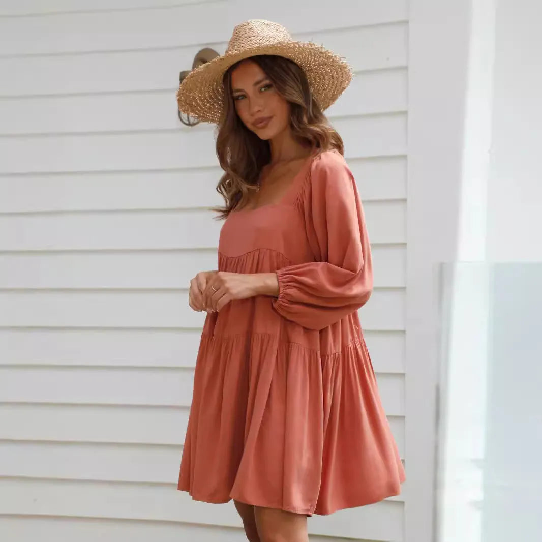 Orange red children's backless dress with a square collar and puff sleeves, showing A-line skirt and loose waist.
