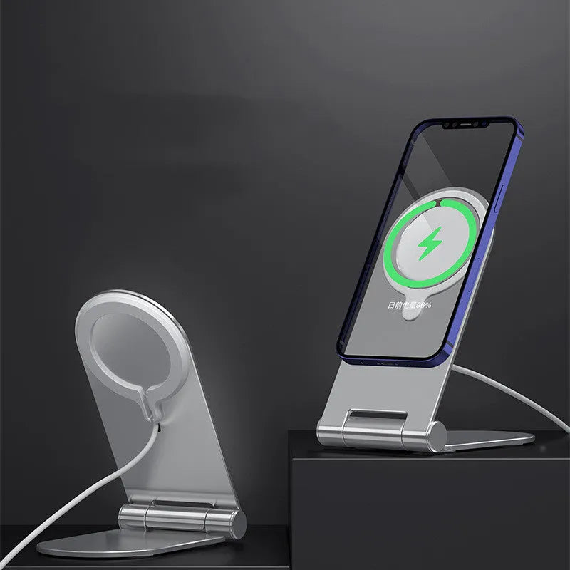 Silver portable magnetic bracket for iPhone 12, showing adjustable vertical stand on a desk.