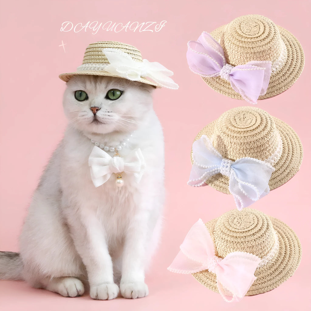 Cat wearing a woven straw hat with a pearl butterfly bow on its head.