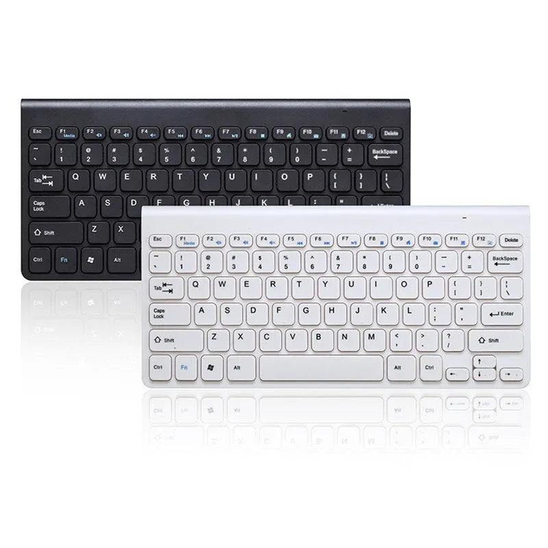 Black and white wireless keyboard and mouse set on a wooden desk