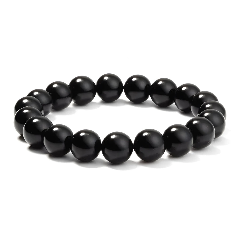Women's black onyx bead bracelet with geometric design on a stretchy elastic cord.