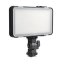 Slim silver Shenniu M150 LED video light with bracket on a mobile phone.