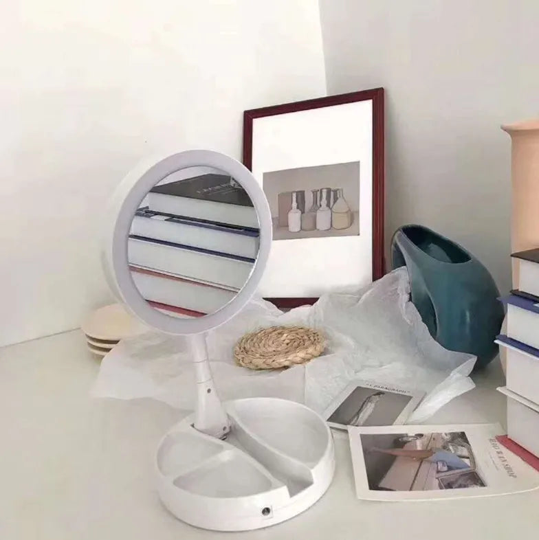 White foldable double-sided LED vanity mirror with USB charging port and storage compartments