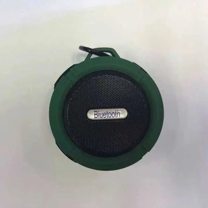 Compact portable Bluetooth stereo speaker with mountaineering buckle, shown in multiple colour options.
