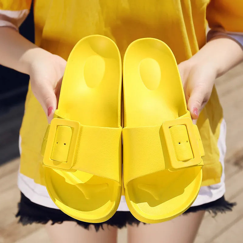 Women's grey blue buckle slippers with a soft EVA sole and single buckle closure.