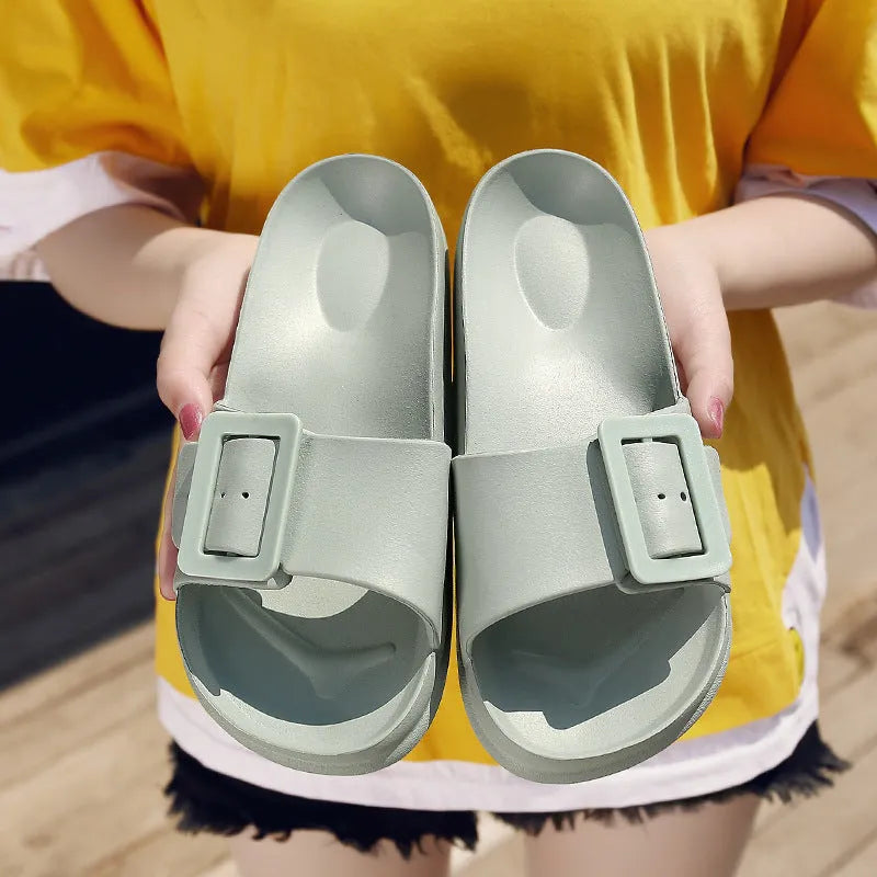 Women's grey blue buckle slippers with a soft EVA sole and single buckle closure.