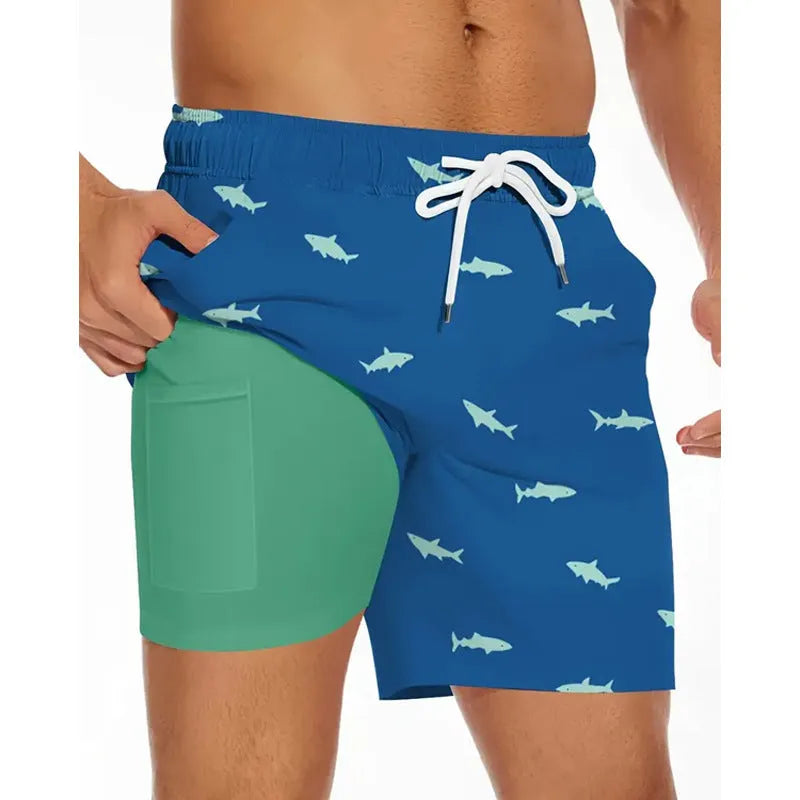 Man wearing loose grey polyester beach shorts on a sandy shore